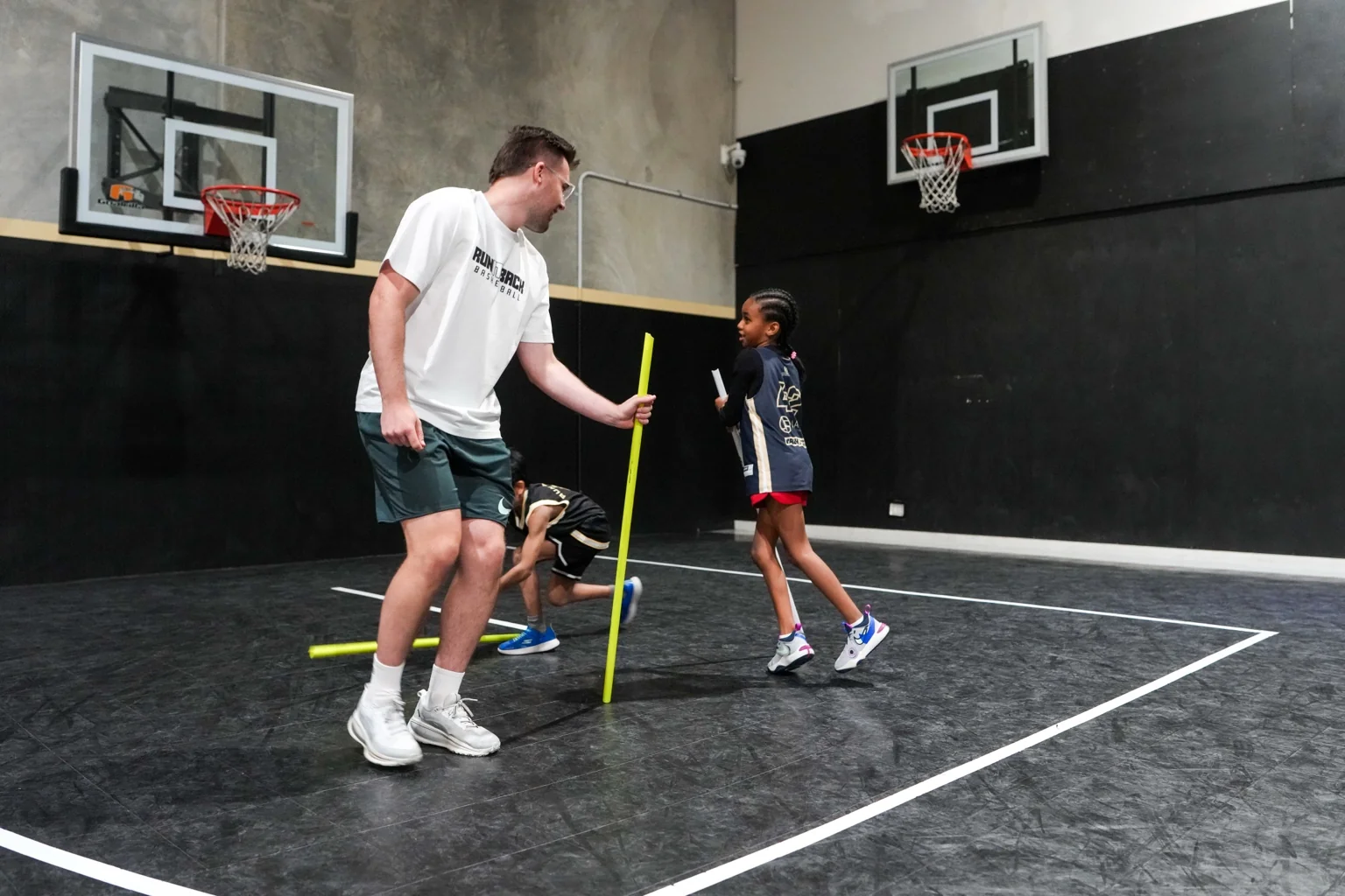 Arie coaching young athletes through a reaction and agility drill