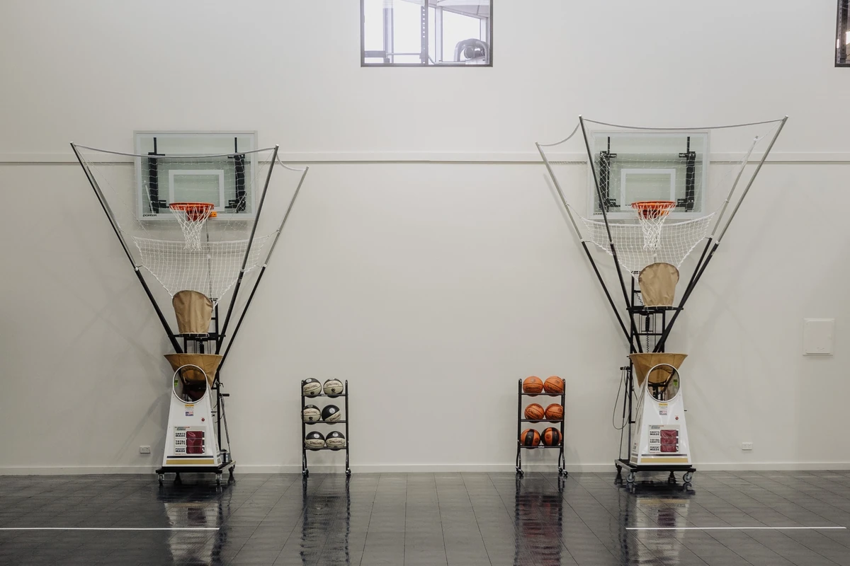 Two shooting machines ready for basketball practice at Run It Back